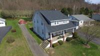 Small mid-class home with a gray shingle roof